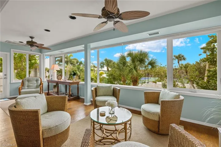 Sunroom / solarium featuring ceiling fan