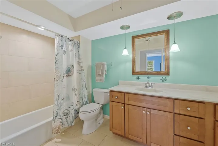 Guest bathroom features a tub and shower.