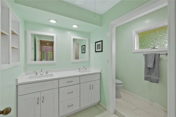 Newly revnovated primary bathroom features dual sinks and a walk-in shower.