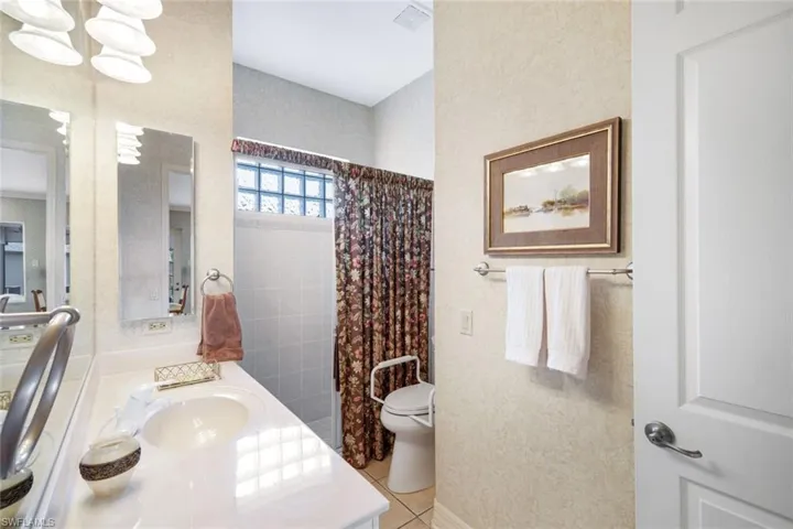 One of the Guest Bathrooms- Offers Regular Entry or Private Bedroom Entry- Step In Entry Shower w/Glass Doors