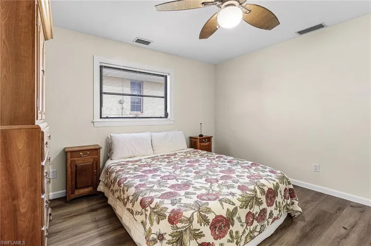 Bedroom featuring dark wood-type flooring and ceiling fan