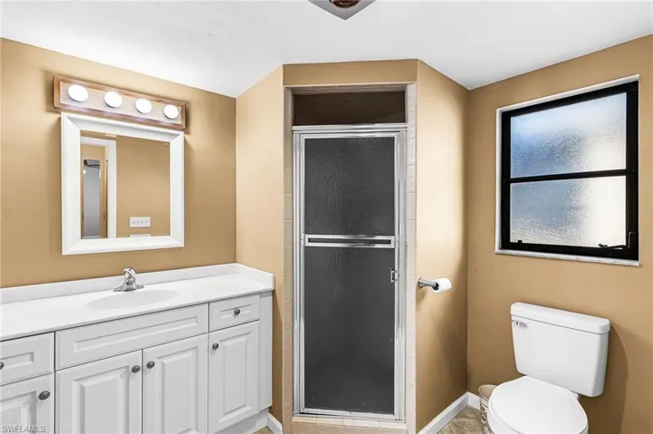 Bathroom featuring vanity and a shower stall