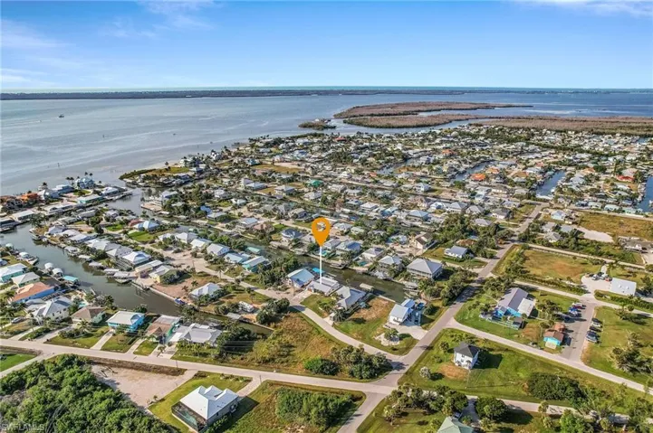 Aerial overview of property's location featuring nearby suburban area and a large body of water