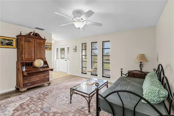 Living room featuring LVP floors and a ceiling fan