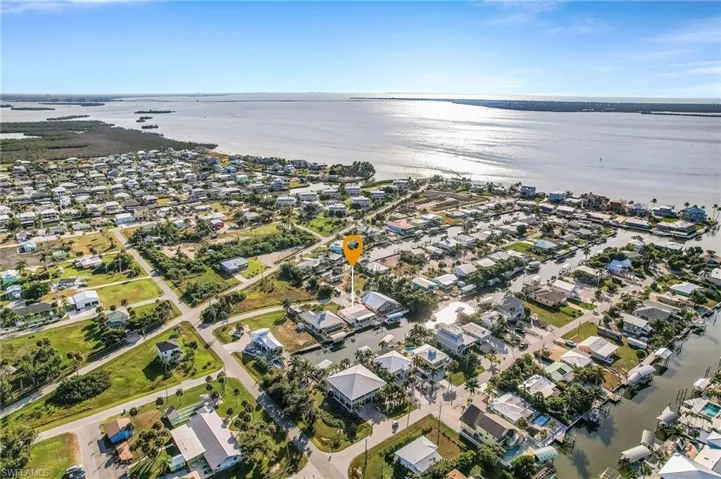 View of property location featuring a large body of water and nearby suburban area