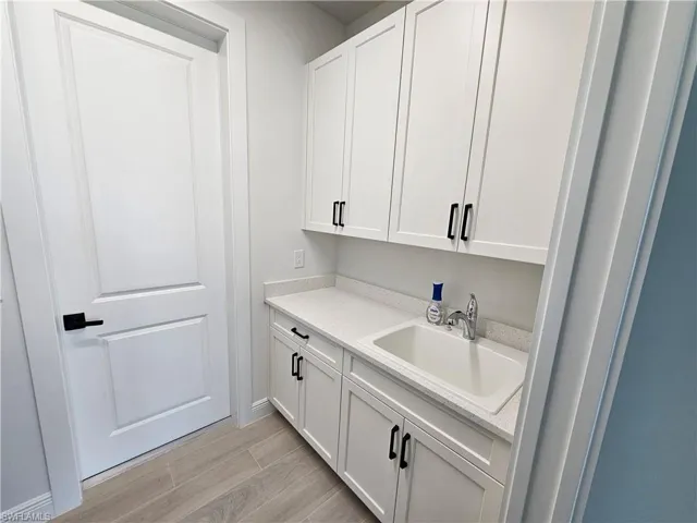 Cabinets and sink in laundry