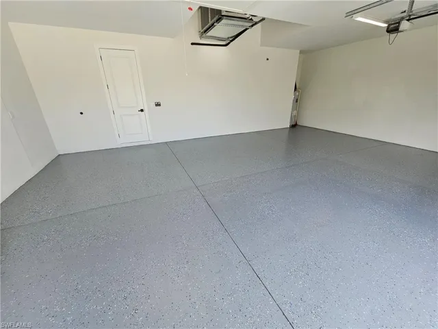 Large 3-car garage with epoxy floring an quiet belt driven garage door openers