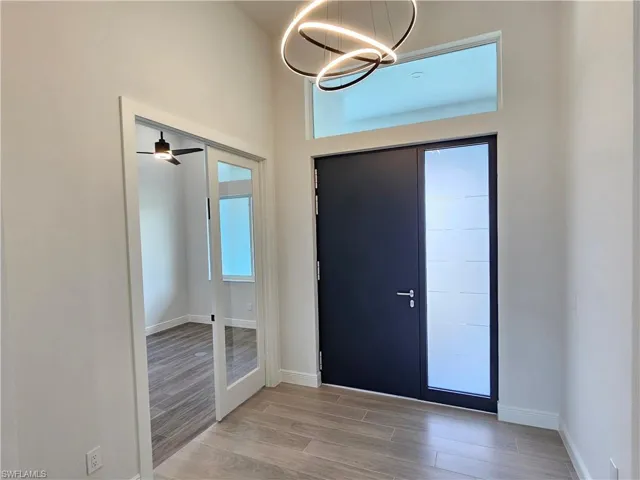 Foyer with German high security entry door, french doors towards den