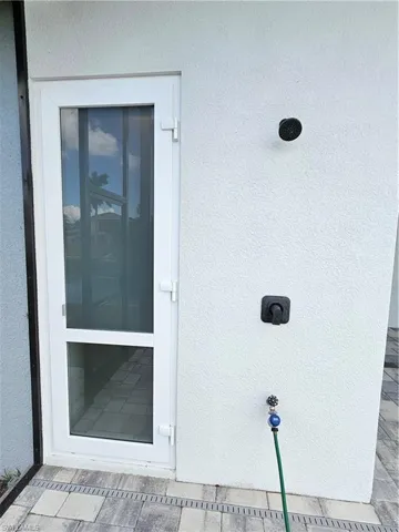 German exterior door towards pool bathroom and outdoor shower