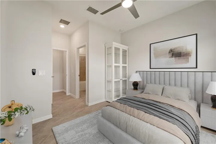 Bedroom 4 with ensuite bath, ceiling fan, and light tile patterned floors
