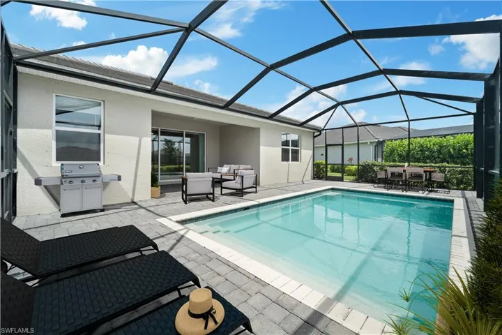 Virtually staged screened in pool and covered lanai
