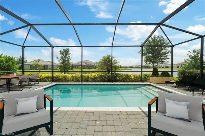 Virtually Staged screened in pool with lake view.