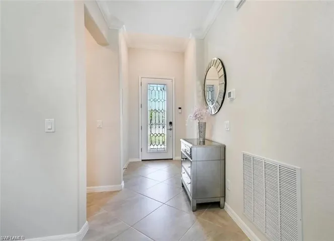 Tiled entrance foyer with crown molding