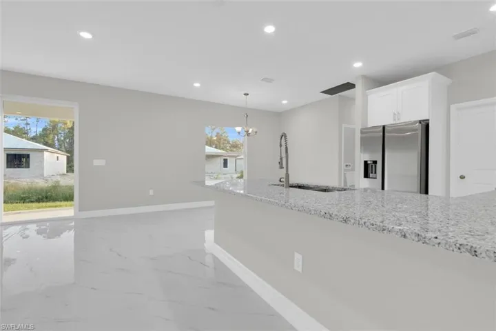 Kitchen island with a granite countertop and an undermount sink