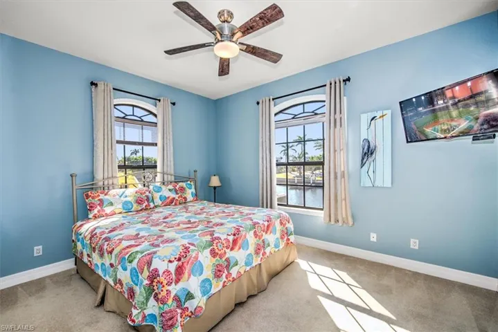 Carpeted bedroom with ceiling fan
