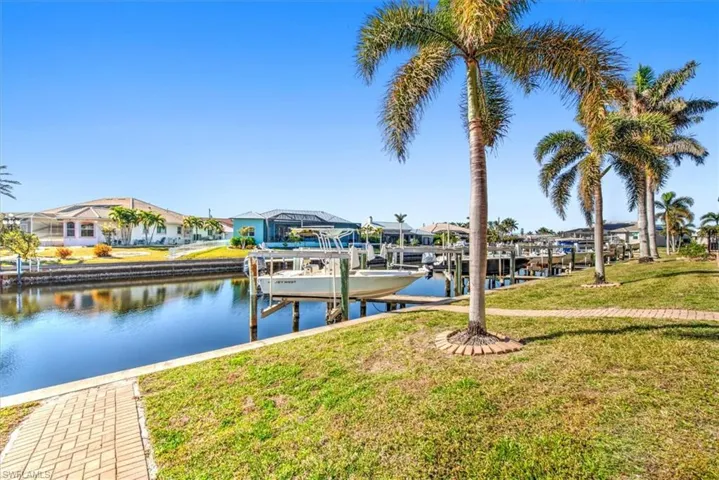 View of dock featuring a water view and a lawn