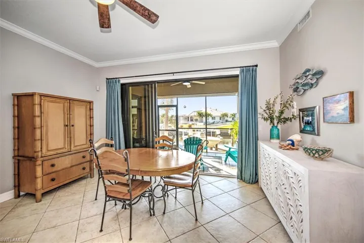 Tiled dining area with crown molding