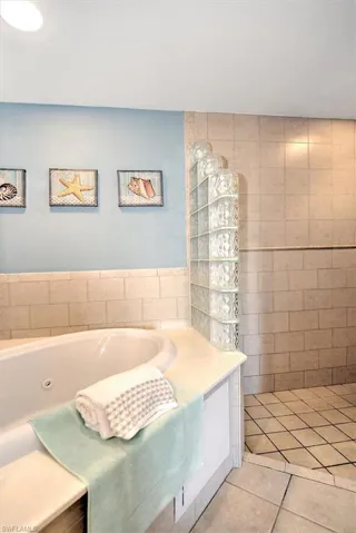 Bathroom featuring a washtub and tile patterned floors