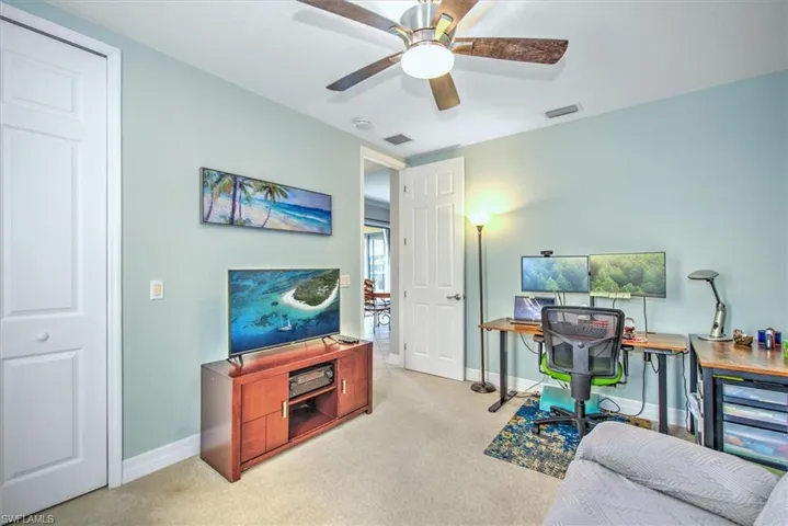 Office featuring ceiling fan and light carpet