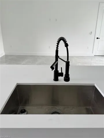 Kitchen view of a sink and baseboards