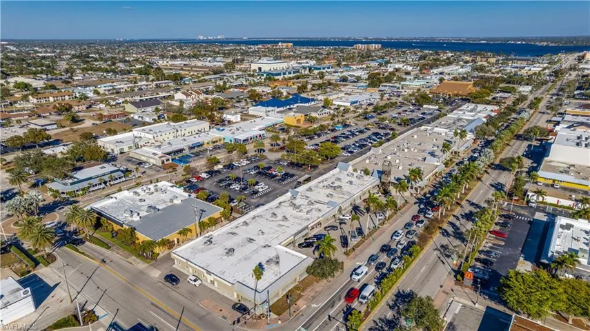 Aerial view of property's location with a commercial area