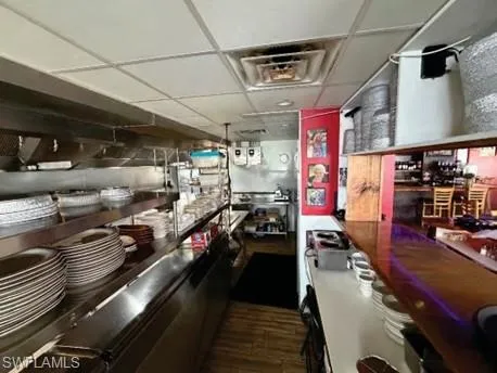 Kitchen with a drop ceiling and black oven