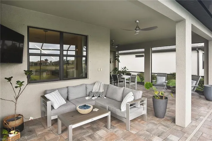 View of patio with an outdoor living space and ceiling fan