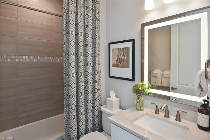 Full bathroom featuring vanity, toilet, and shower / bath combo with shower curtain