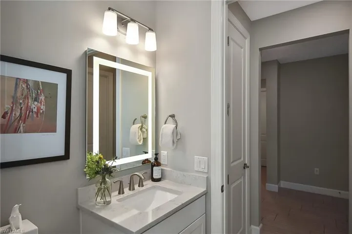 Bathroom with hardwood / wood-style flooring and vanity