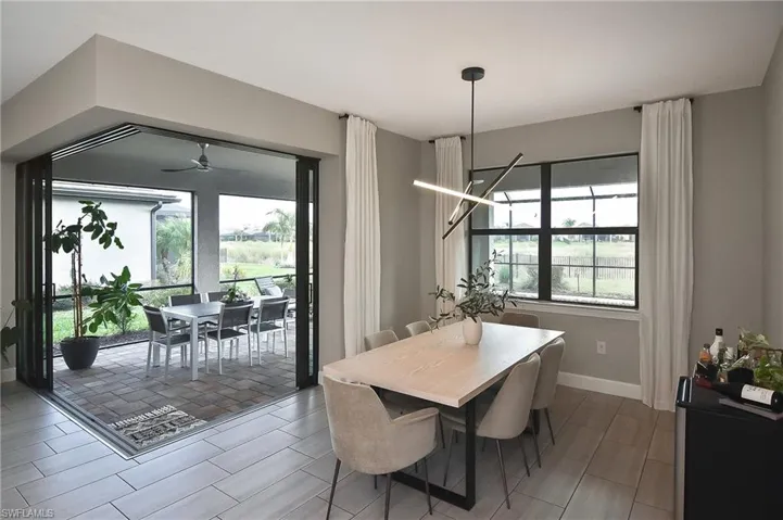 Dining space featuring ceiling fan with notable chandelier