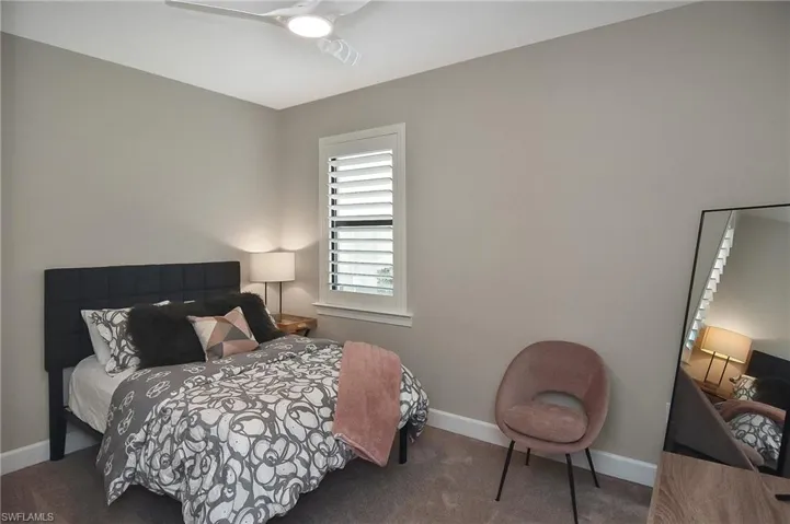 Bedroom with ceiling fan and carpet