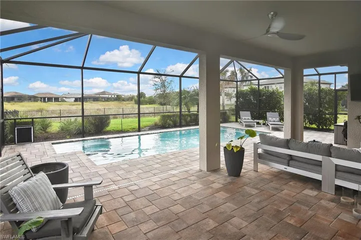 View of swimming pool featuring an outdoor living space, a patio, and glass enclosure