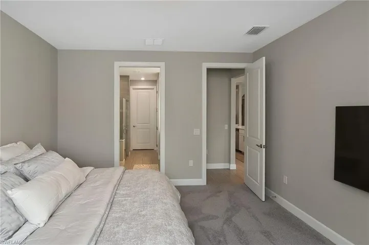 Bedroom featuring light colored carpet