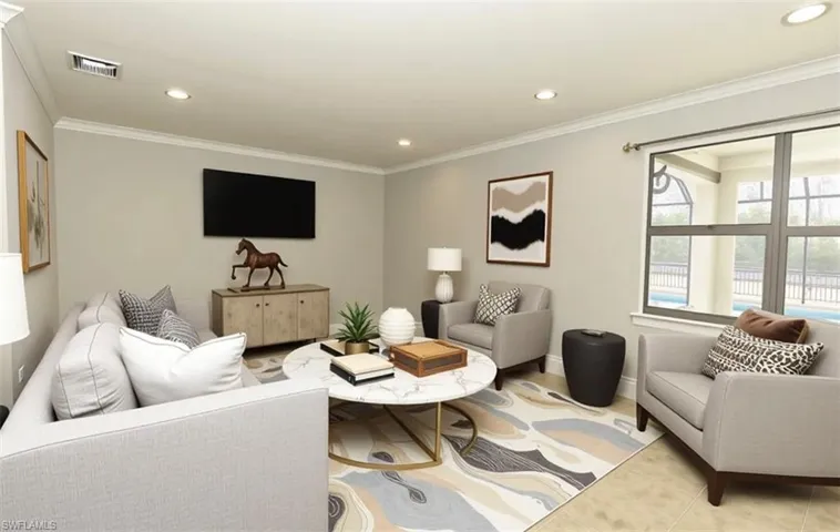 Living room with recessed lighting and ornamental molding