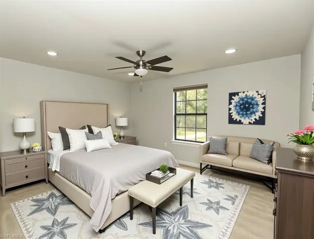 Bedroom featuring ceiling fan, recessed lighting, and light colored carpet