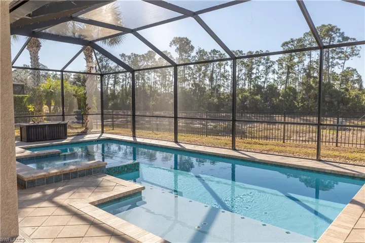 Integrated pool / spa featuring a lanai, a sunroom, and a patio area
