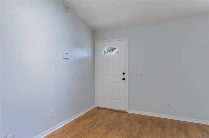 Entryway with wood finished floors and baseboards