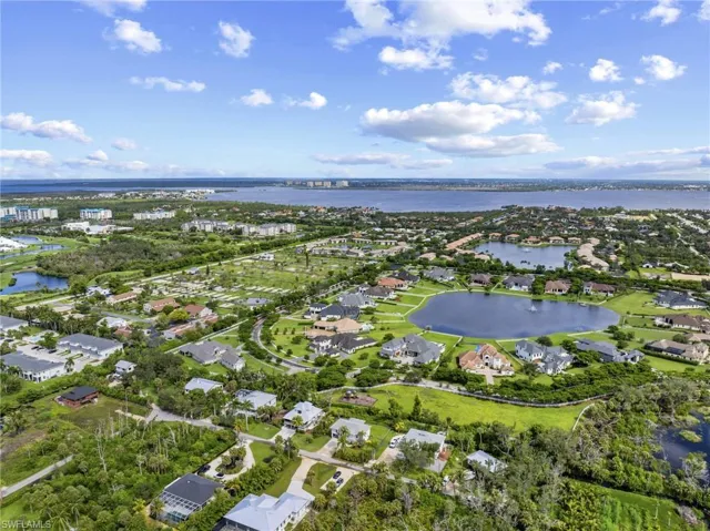 Aerial overview of property's location with nearby suburban area and a nearby body of water