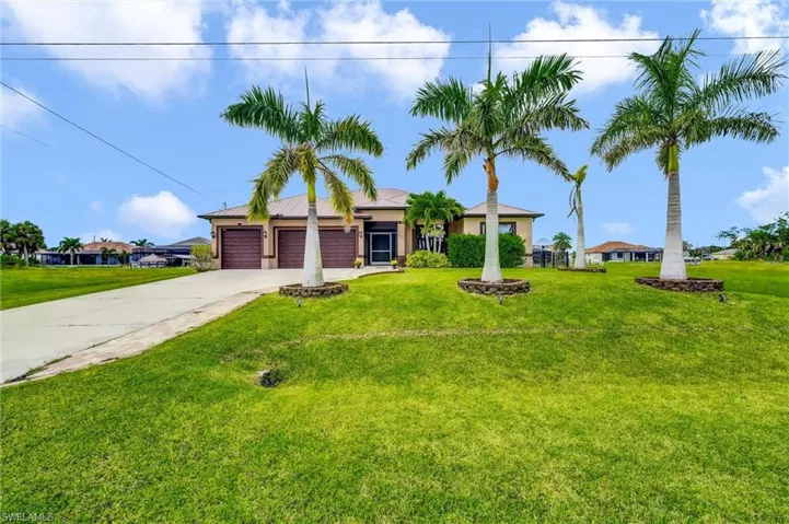Ranch-style home featuring a front yard, concrete driveway, an attached garage, and stucco siding