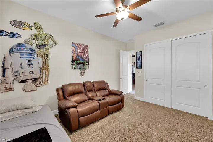 Large Enclosed and screened Lanai featuring a vast water view and a ceiling fan