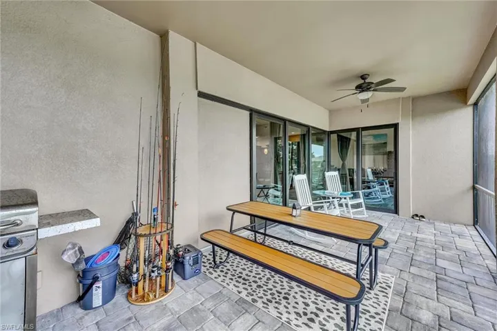 Large Enclosed and screened Lanai featuring a vast water view and a ceiling fan