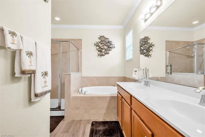 Dual vanity with white countertops and wood-finish cabinetry