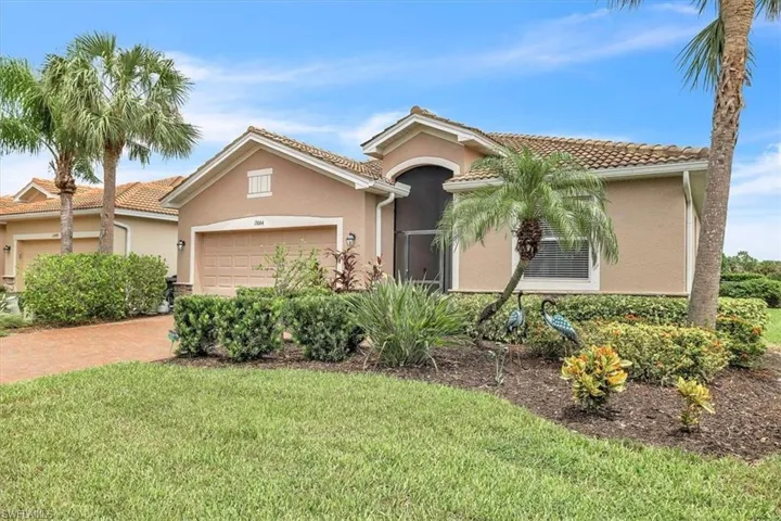 Stucco exterior with a tile roof, an integrated garage, and a screened entry
