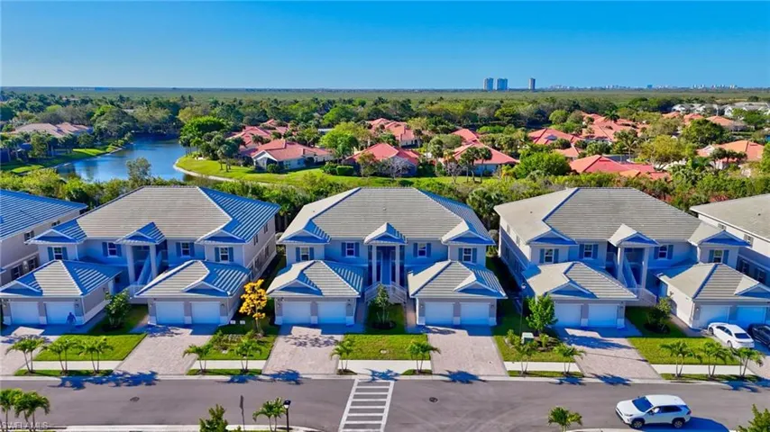 Aerial perspective of suburban area featuring a large body of water