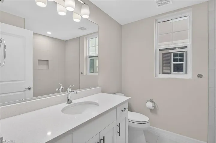 Full bathroom with vanity and light tile patterned floors