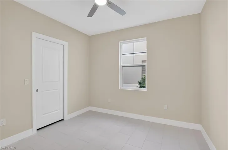 Unfurnished room featuring baseboards and a ceiling fan