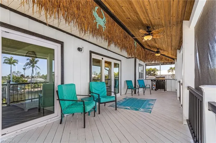Upper deck overlooking pool and canal hurricane impact sliders.