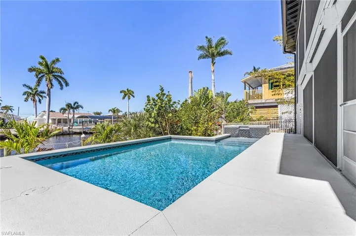 Heated pool and spillover spa overlooking the canal.