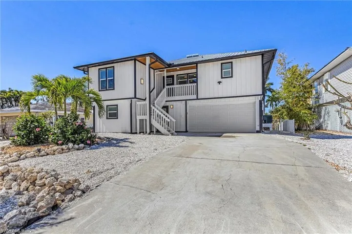Double-wide concrete driveway and maintenance-free yard.