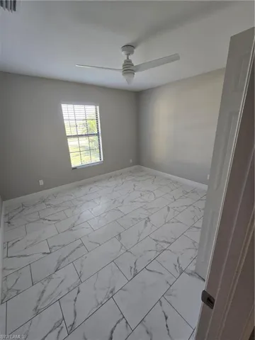 Unfurnished room featuring ceiling fan